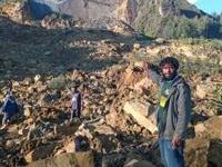 People gather at the site of a massive landslide in Papua New Guinea's Enga province