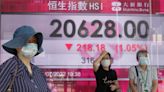 Asian shares slip as investors eye inflation, earnings