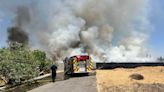 Firefighters battle grass fire near Golden West High School in Visalia