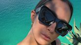 Frankie Bridge shows off her toned figure in a black cut-out swimsuit