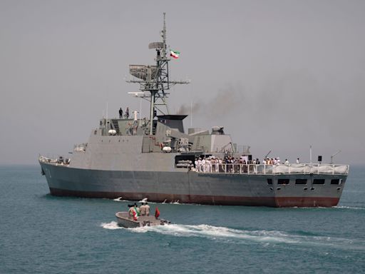 An Iranian frigate was seen capsizing at port while next to merchant ships, another black mark for the country's record of naval mishaps