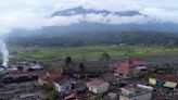 Indonesian rescuers search through rivers and rubble after flash floods that killed at least 52