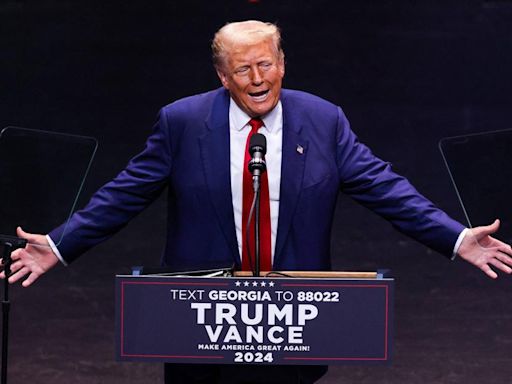 Donald Trump Trolled Over His 'Small Head' as He Tosses Chicken Nuggets Into a Crowd at Alabama Game — Watch