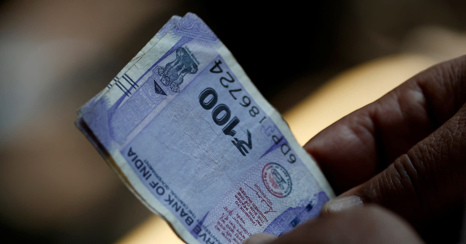 Indian rupee drops to lifetime low on outflow worries