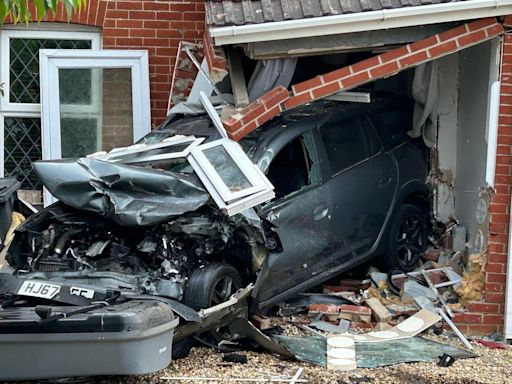 Car smashes through front of house after crash