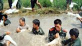 A million people worked to repair broken dikes as floods inundated China in 2002