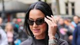 Katy Perry covers up in a quirky black ensemble as she heads to radio