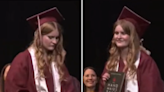 Footage shows moment student pulls out banned book at her graduation