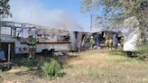 Family escapes with dogs after fire from neighbor's mobile home spreads