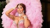 Cardi B stars in a new Beats ad and addresses the Twitter frenzy over her tattooed wig