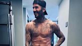 Victoria Beckham treats her fans to a shirtless snap of husband David as they enjoy couple's workout