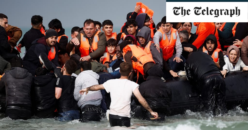 Watch: Moment dozens of migrants rush to board boat to cross the Channel