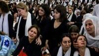 Druze women mourn by a coffin during a funeral after a rocket strike from Lebanon which, Israel's military said, killed 12 young people