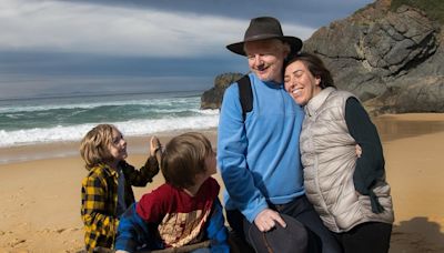 Julian Assange poses with his wife and children on Australian beach