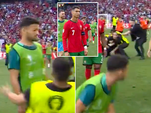 Security guard injures Portugal forward Goncalo Ramos after full-time whistle as pitch invaders cause mayhem