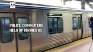 Police: commuters held up phones as woman raped