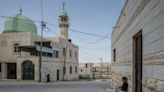 In the West Bank, Guns and a Locked Gate Signal a Town’s New Residents