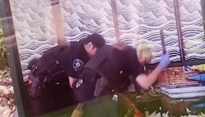2 police officers under investigation after they were recorded beating a man with batons at a bus stop