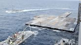 US CENTCOM says first trucks carrying aid have moved ashore via temporary pier