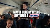 SNICKERS SATISFIES AGAIN WITH NEW CAMPAIGN THAT PROFILES THE OUT-OF-SORTS BEHAVIOR OF PASSENGERS TRYING TO NAVIGATE THE...