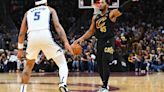 Donovan Mitchell of the Cleveland Cavaliers handles the ball against Paolo Banchero of the Orlando Magic during the third quarter in Game 7 of the Eastern Conference...