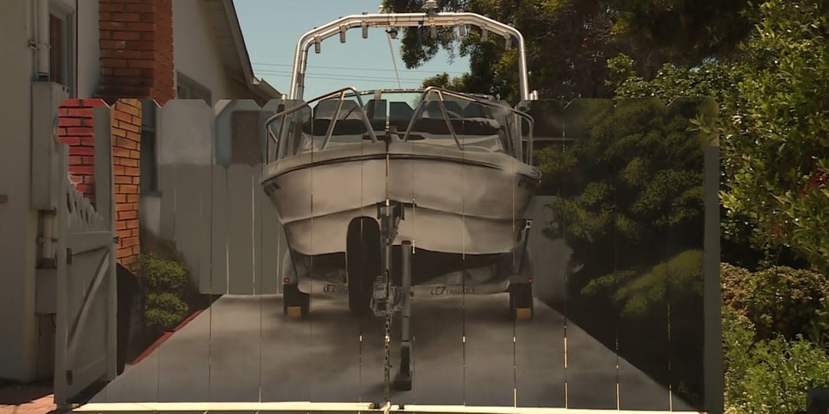 Man gets boat painted on fence that city made him put up to hide it