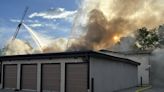 Arvada crews battle storage unit fire burning along I-70, smoke blinds morning commuters