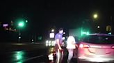 Moment police officer struck in hit-and-run while helping motorist
