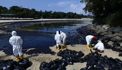 Singapore says dredger that hit tanker reported sudden loss of control, oil spill cleanup ongoing