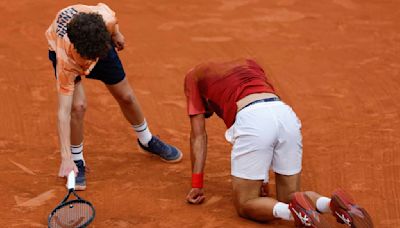 Novak Djokovic wins his record 370th Slam match but isn't sure he can continue at the French Open