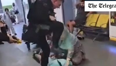 Armed policeman filmed ‘kicking man’s head’ during airport confrontation