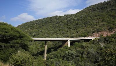 Burned bodies of Easter pilgrims still lie inside a bus that crashed off a bridge in South Africa