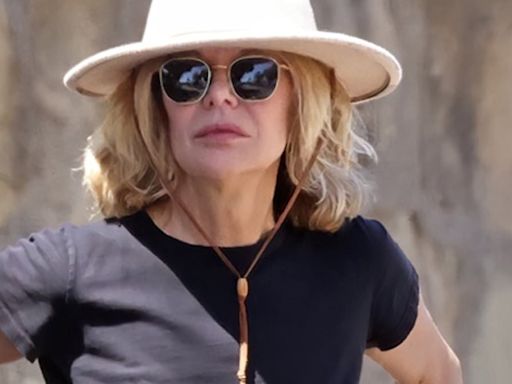 Meg Ryan makes the rare move of flashing her tummy