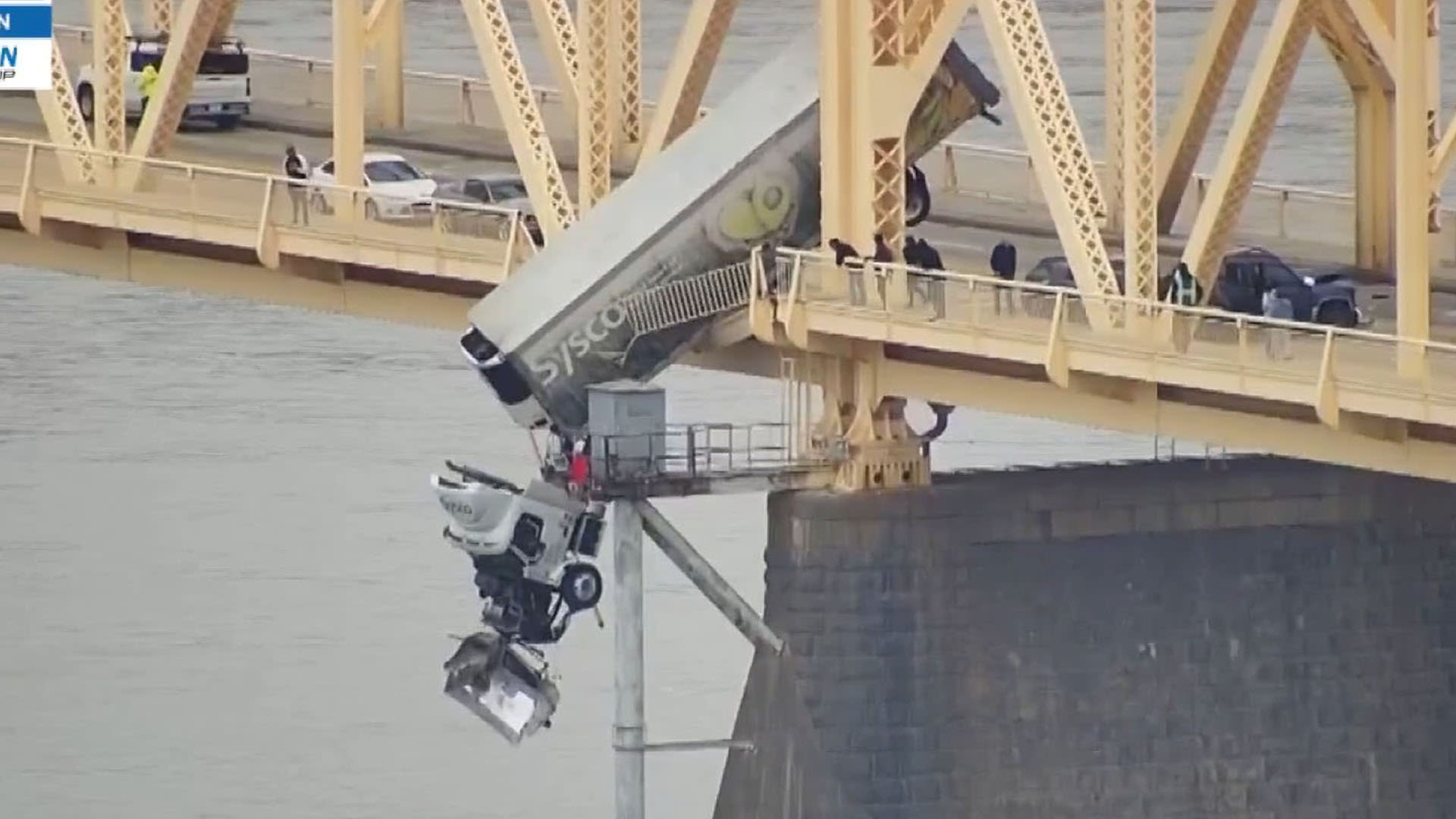 Driver crashes into side railing and flies off bridge with truck left dangling