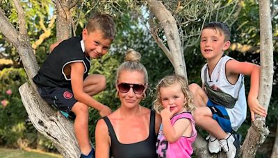 Helen Skelton looks incredible in a black fitted midi dress in Menorca