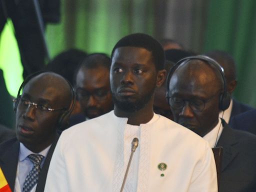 Senegal's leader wasn't born when ECOWAS was founded. He's asked to reunite the bloc split by coups