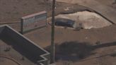 Crash in west Phoenix leaves street flooded, car in apparent sinkhole