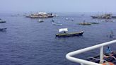 About 100 Filipino activists and fishermen sail on wooden boats to disputed shoal guarded by China