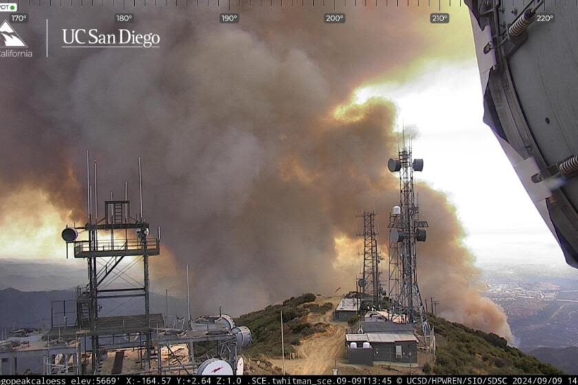 Fast-moving Airport fire erupts near homes in Orange County; three people injured