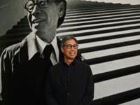 Sandi Pei, son of renowned Chinese-American architect I.M. Pei, poses in front of a photo of his father at a new exhibit at Hong Kong's M+ museum