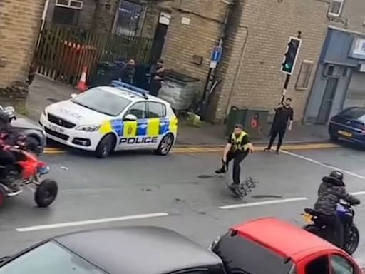 Dramatic moment police officer is struck by a quad bike