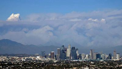 Los Angeles wildfire explodes, engulfing homes