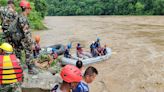 More than 60 people missing after two buses swept into river in Nepal