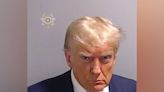 Trump scowls in historic mug shot after arrest at Fulton County Jail