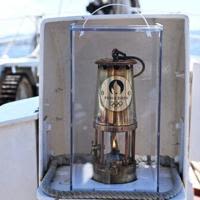 The Olympic flame pictured on board the 19th-century three-masted ship Belem off the coast of Marseille