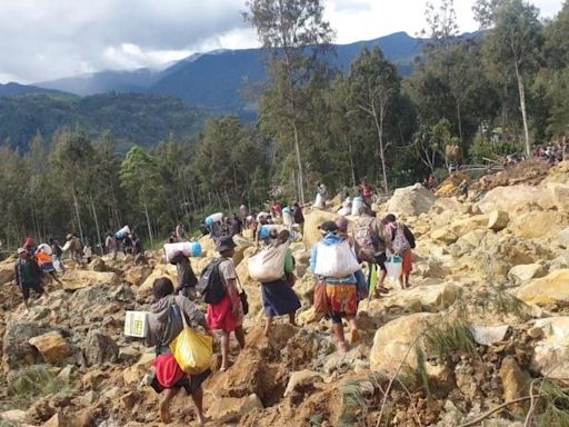 Race to rescue villagers trapped after landslide