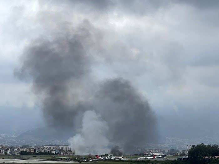 A plane with 19 people on board slips off the runway and crashes at Nepal airport