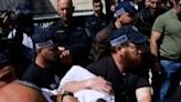 Israeli police detain a man at the site of a reported ramming attack in Jerusalem