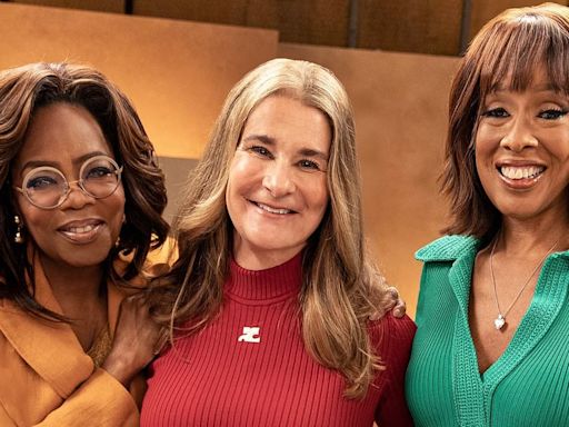 Oprah Winfrey models orange pantsuit with Gayle King and Melinda Gates