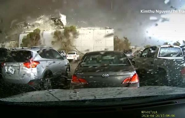 Dashcam captures a tornado destroying a Nebraska building